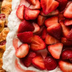 Strawberry Shortcake Sheet Cake topped with fresh sliced strawberries and whipped cream frosting on a golden cake layer, overhead view