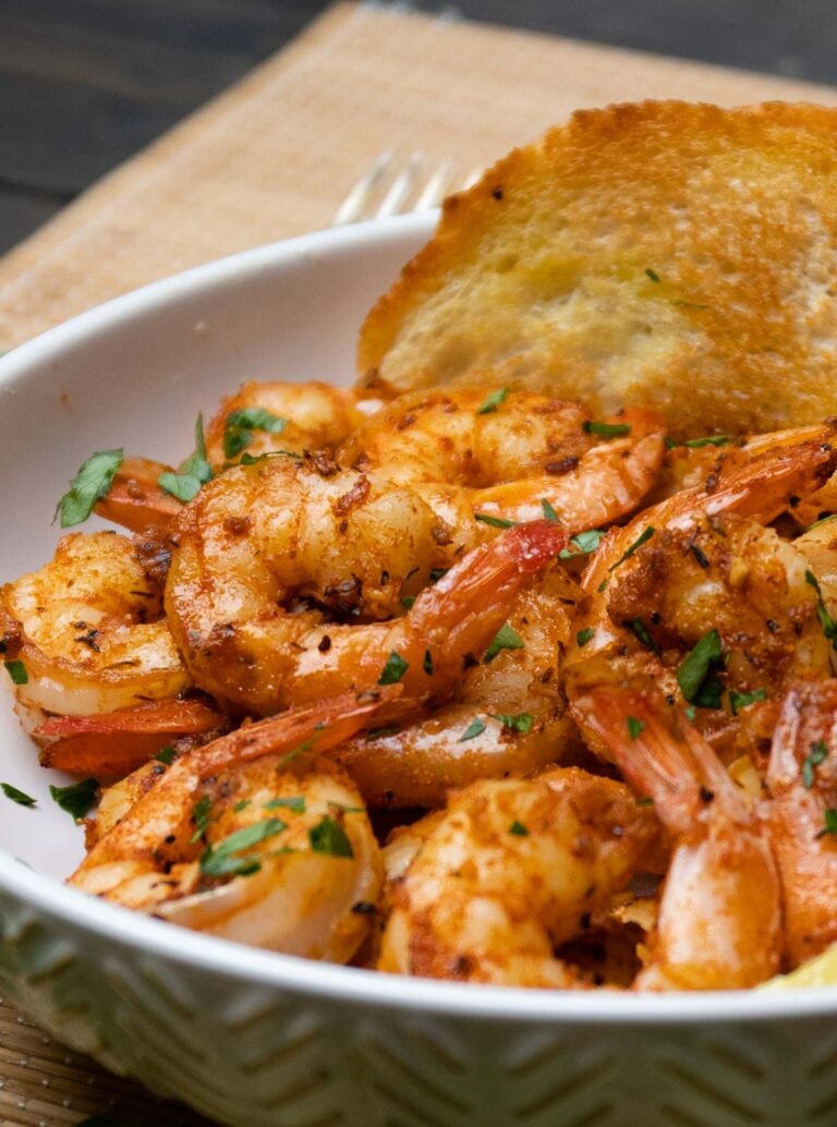 Seasoned shrimp with fresh herbs in white bowl beside cornbread for My Easter Menu: Every Recipe You Need for the Perfect Day