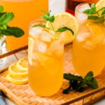 Bourbon Arnold Palmer cocktails with lemon slices and fresh mint