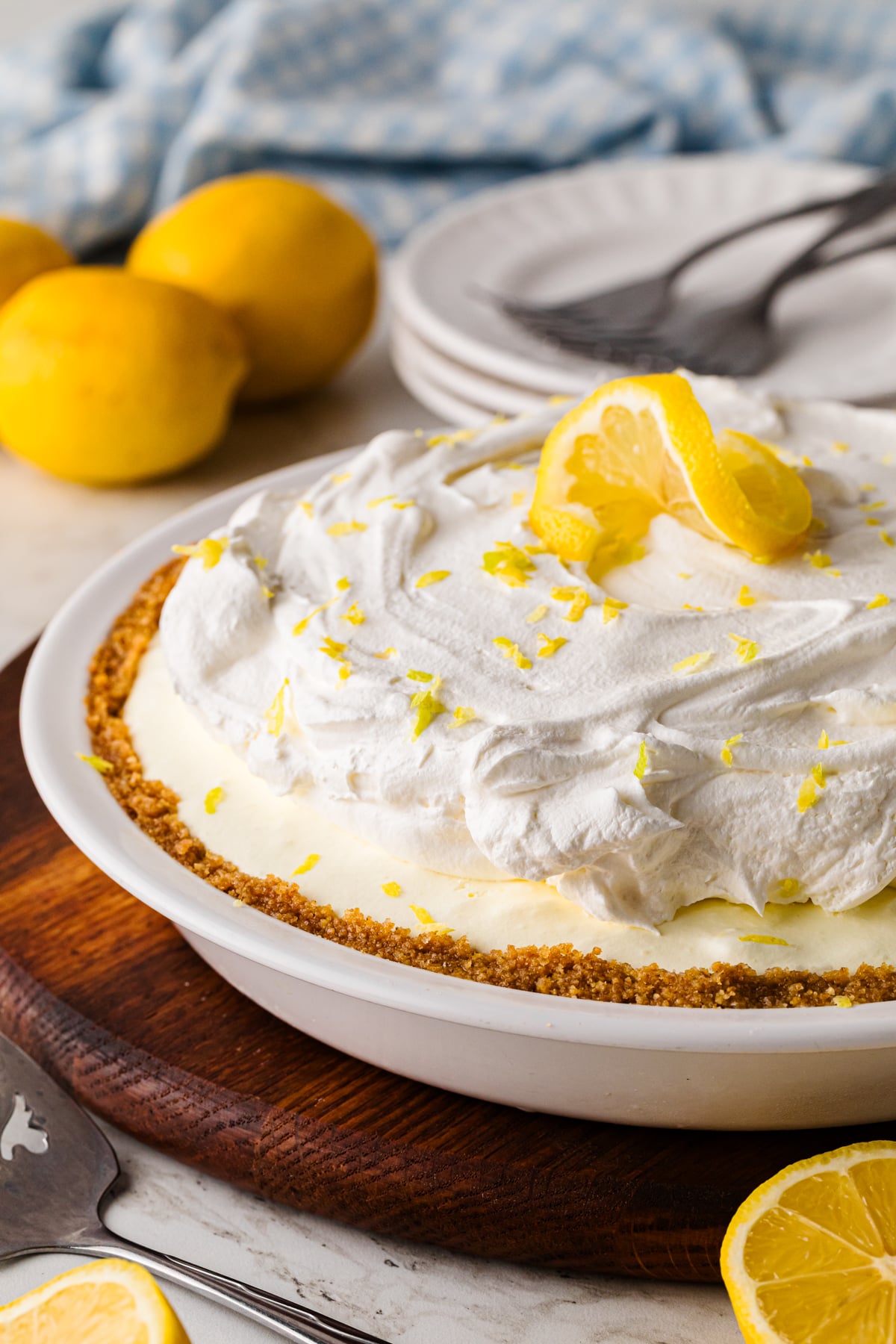 Slice of lemon icebox pie with whipped topping and lemon zest