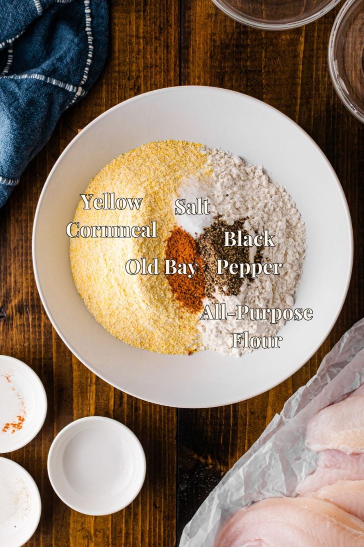 Cornmeal fish fry mix ingredients labeled on a plate with cornmeal, flour, salt, and spices
