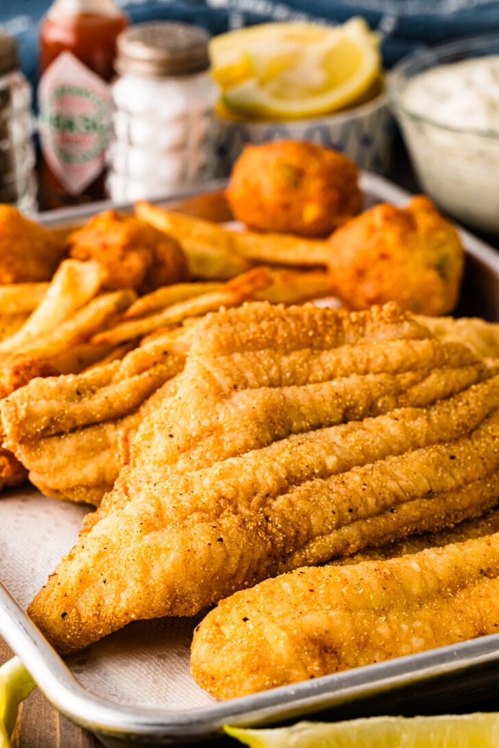 Crispy fried catfish fillets served with fries and hush puppies